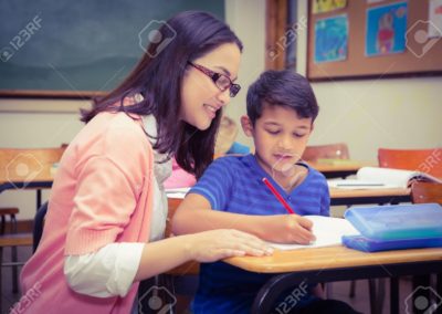 43914758-happy-teacher-helping-her-students-at-the-elementary-school